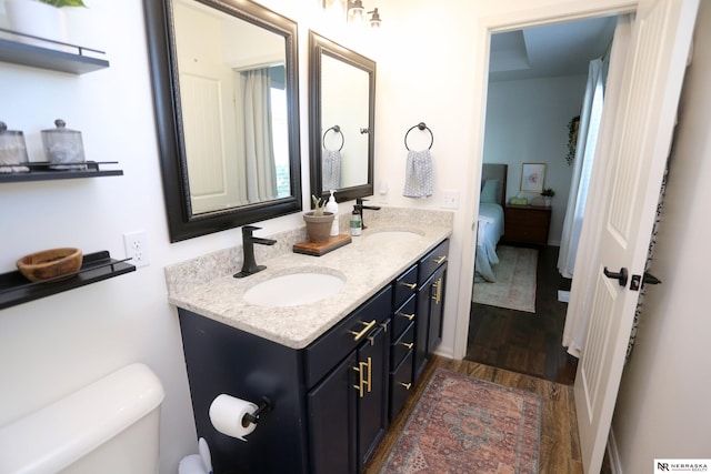 13719 S 43rd Ave, Bellevue, NE 68123 - bathroom featuring double vanity, wood finished floors, and ensuite bath