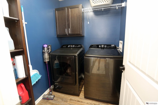 13719 S 43rd Ave, Bellevue, NE 68123 - laundry area featuring independent washer and dryer, cabinet space, and light wood-style floors