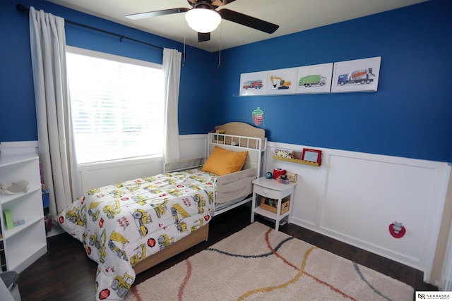 13719 S 43rd Ave, Bellevue, NE 68123 - bedroom featuring wood finished floors, multiple windows, wainscoting, and a ceiling fan