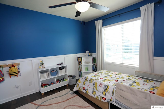 13719 S 43rd Ave, Bellevue, NE 68123 - bedroom with wainscoting, wood finished floors, a ceiling fan, and a decorative wall