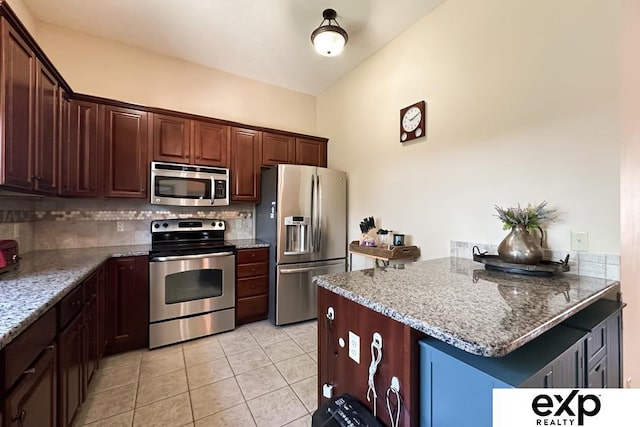 2611 N 189th St, Elkhorn, NE 68022 - kitchen featuring appliances with stainless steel finishes, tasteful backsplash, light tile patterned floors, a peninsula, and stone countertops