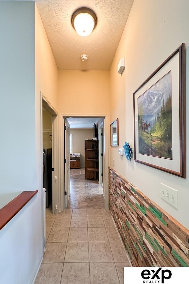 2611 N 189th St, Elkhorn, NE 68022 - corridor featuring a textured ceiling and light tile patterned floors