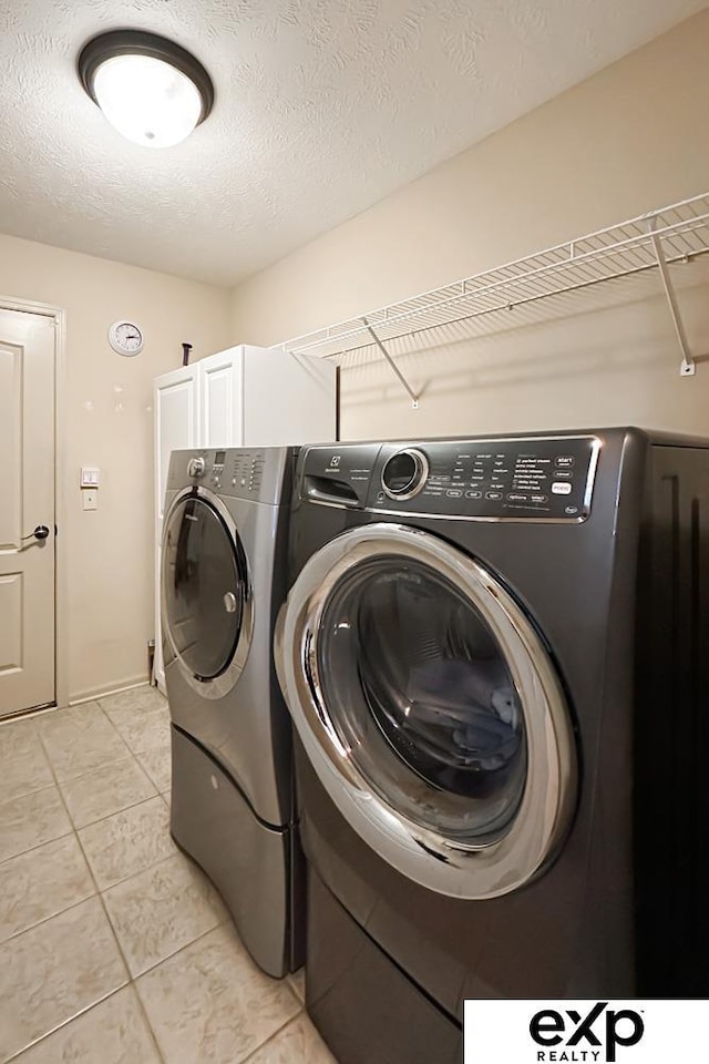 2611 N 189th St, Elkhorn, NE 68022 - washroom featuring washing machine and dryer, light tile patterned floors, and a textured ceiling