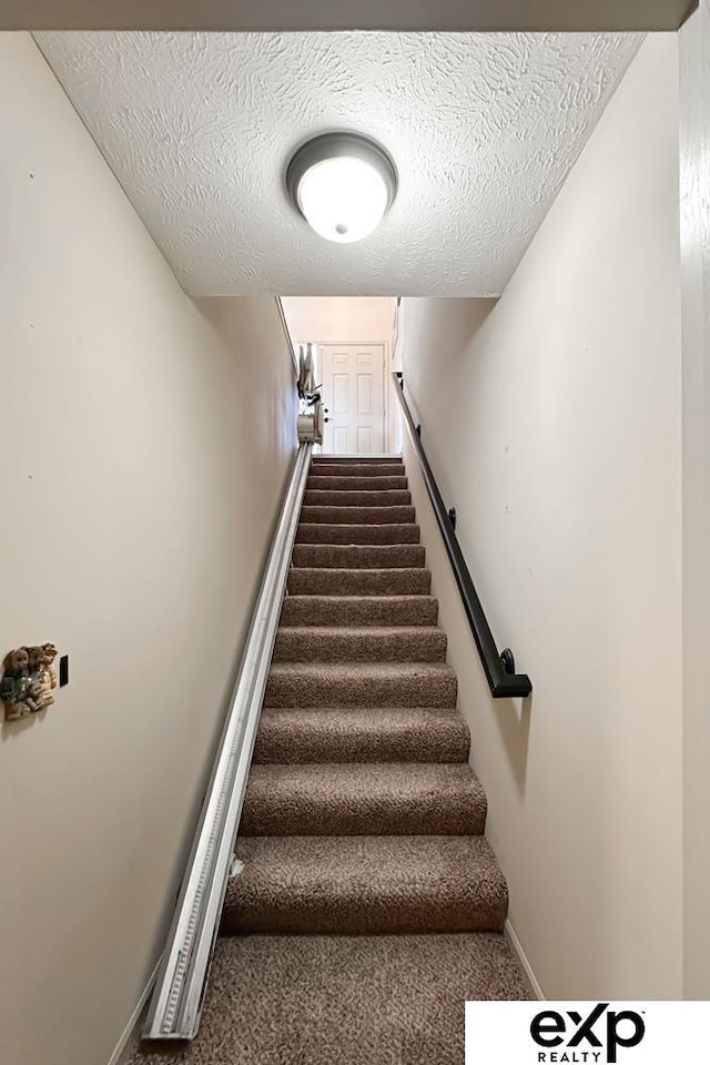 2611 N 189th St, Elkhorn, NE 68022 - staircase featuring a textured ceiling and carpet floors