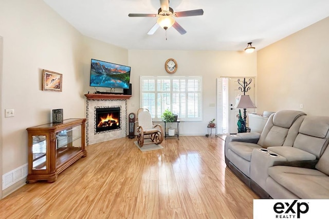 2611 N 189th St, Elkhorn, NE 68022 - living room with light wood-type flooring, ceiling fan, and a tiled fireplace