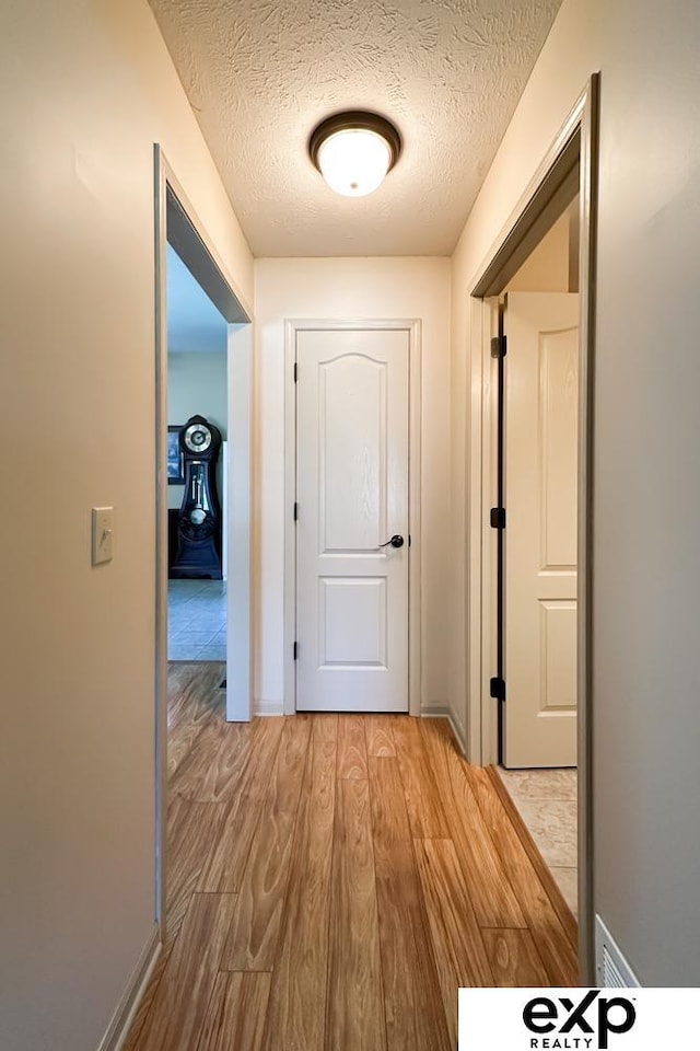 2611 N 189th St, Elkhorn, NE 68022 - corridor with light wood-style flooring and a textured ceiling