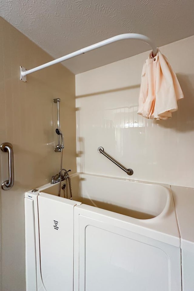 2611 N 189th St, Elkhorn, NE 68022 - washroom with a textured ceiling and washer / dryer