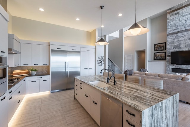 6217 N 295th St, Valley, NE 68064 - kitchen featuring stainless steel appliances, modern cabinets, a spacious island, white cabinets, and dark stone countertops