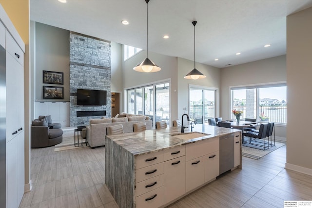 6217 N 295th St, Valley, NE 68064 - kitchen featuring dishwasher, healthy amount of natural light, light stone countertops, a stone fireplace, and recessed lighting