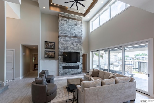 6217 N 295th St, Valley, NE 68064 - living area with a towering ceiling, a fireplace, ceiling fan, recessed lighting, and light tile patterned flooring
