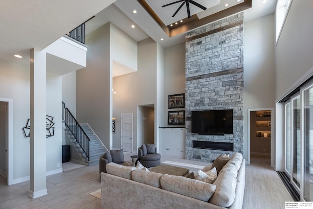 6217 N 295th St, Valley, NE 68064 - living room featuring a towering ceiling, plenty of natural light, a fireplace, stairway, and recessed lighting
