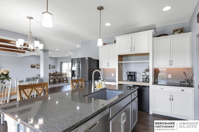 13510 S 46th St, Papillion, NE 68133 - kitchen with stainless steel appliances, a chandelier, backsplash, a center island with sink, and white cabinetry