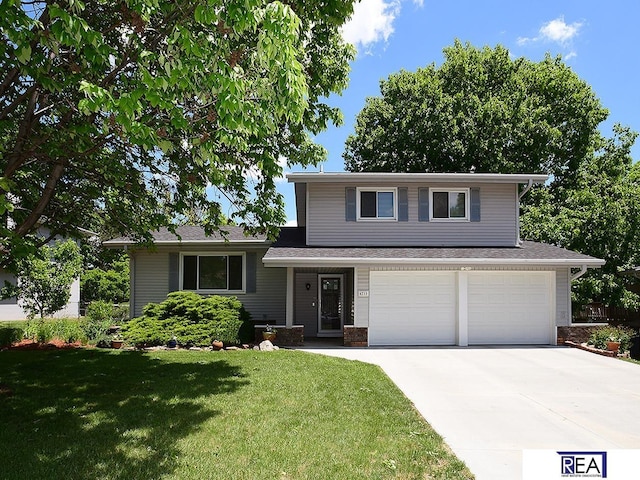 4711 S 102nd St, Omaha, NE 68127 - tri-level home featuring driveway, a garage, and a front yard