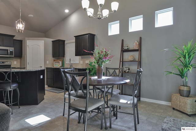 17457 Ames Ave, Omaha, NE 68116 - dining room with high vaulted ceiling and a chandelier