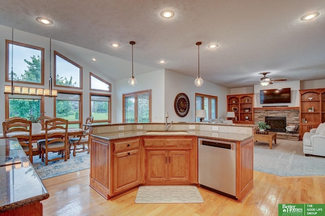 19311 Josephine St, Gretna, NE 68028 - kitchen with dishwasher, a textured ceiling, a fireplace, light stone counters, and light wood finished floors