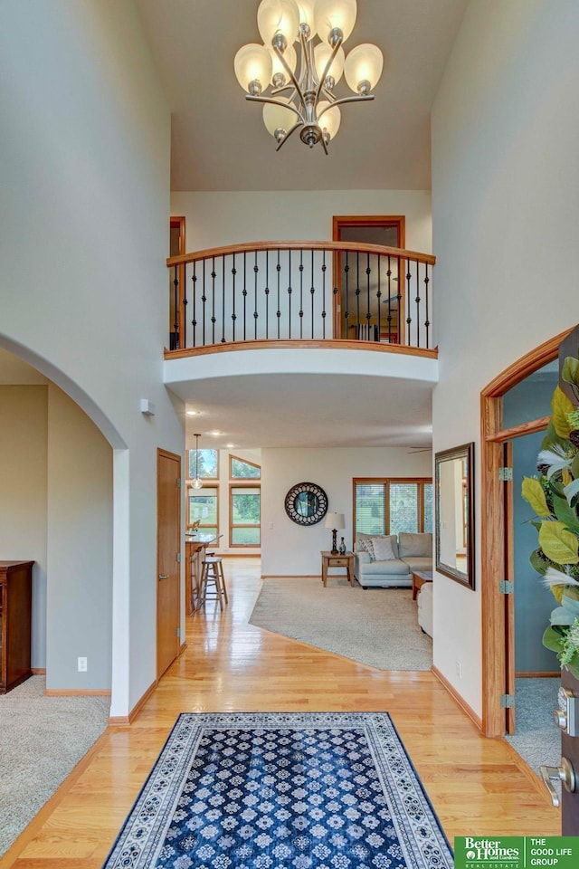 19311 Josephine St, Gretna, NE 68028 - entrance foyer featuring a towering ceiling, arched walkways, wood finished floors, and a chandelier