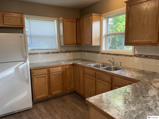 4317 Emmet St, Omaha, NE 68111 - kitchen with freestanding refrigerator, tasteful backsplash, and dark wood-type flooring