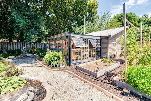 1420 Easy St, Trumann, AR 72472 - rear view of house with a garden, metal roof, and an outbuilding
