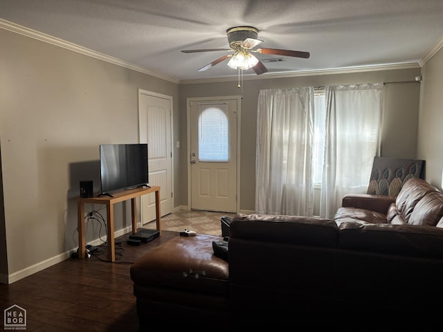 living area with ornamental molding, ceiling fan, hardwood / wood-style floors, and baseboards