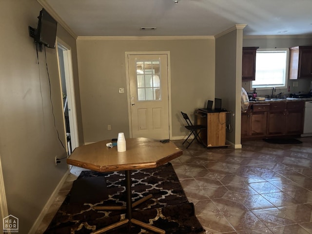 entryway with crown molding, visible vents, and baseboards