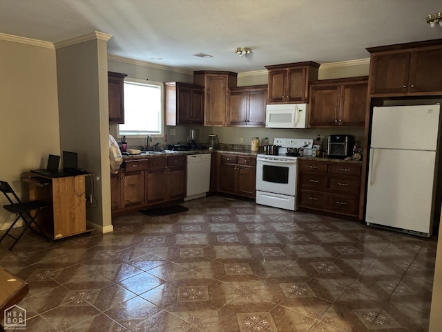kitchen featuring white appliances, crown molding, dark countertops, visible vents, and a sink