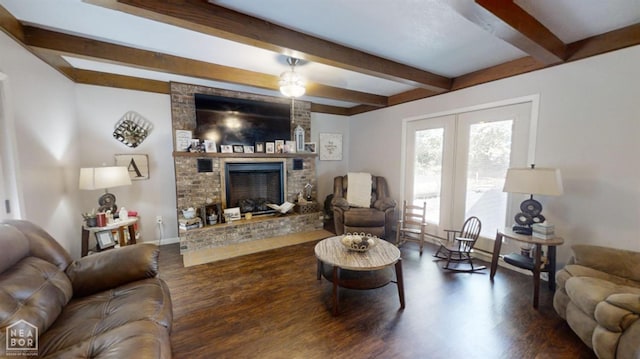 living room with wood finished floors, beam ceiling, and a brick fireplace