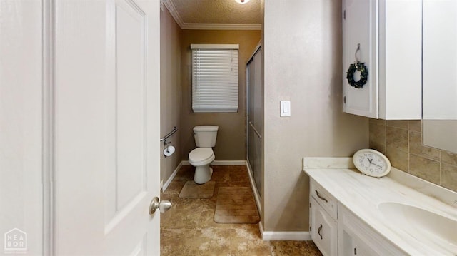 bathroom featuring baseboards, toilet, a textured ceiling, crown molding, and vanity