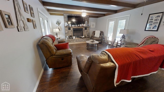 living room with beamed ceiling, baseboards, a brick fireplace, and wood finished floors
