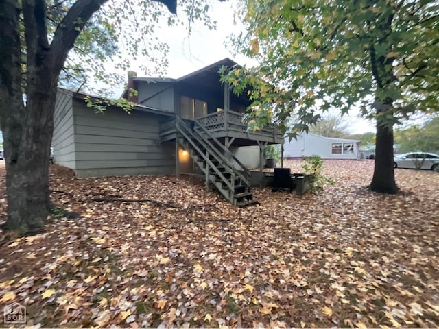 view of home's exterior with a deck and stairs
