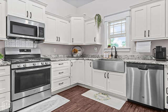 5301 Bridger Park Ct, Jonesboro, AR 72405 - kitchen featuring stainless steel appliances, white cabinetry, dark wood-style floors, and light stone counters