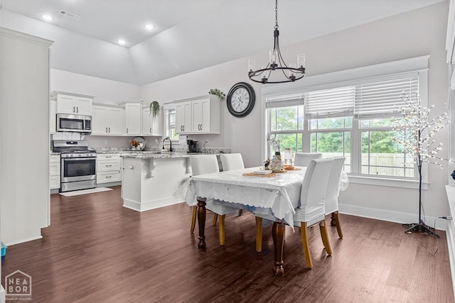 5301 Bridger Park Ct, Jonesboro, AR 72405 - dining space featuring a chandelier, dark wood-style flooring, a high ceiling, and recessed lighting