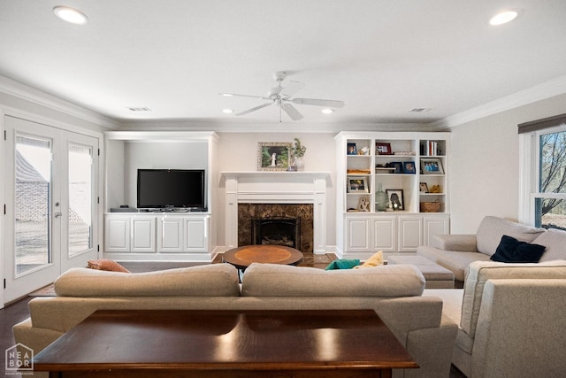 living area with a premium fireplace, ornamental molding, a ceiling fan, and recessed lighting