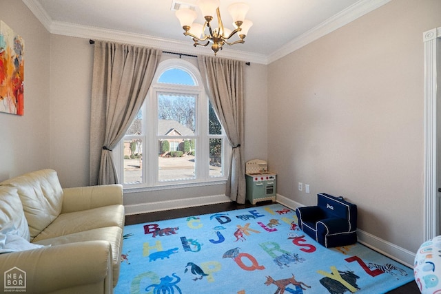 living area with wood finished floors, an inviting chandelier, baseboards, and ornamental molding