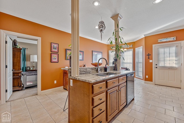 kitchen with a sink, decorative columns, a center island with sink, stainless steel dishwasher, and light tile patterned flooring