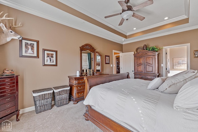bedroom featuring baseboards, ornamental molding, light carpet, recessed lighting, and a tray ceiling