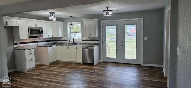 kitchen with a sink, french doors, dark wood-style floors, and stainless steel appliances