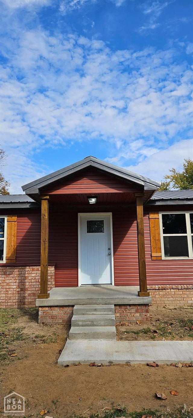 view of front facade with a porch and stone siding