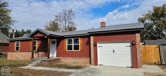 single story home featuring driveway, crawl space, an attached garage, metal roof, and fence