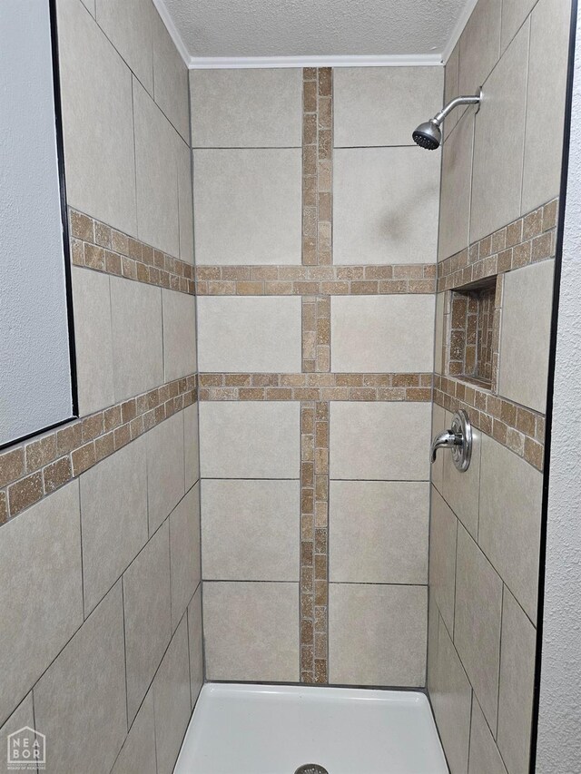 full bathroom featuring a stall shower and a textured ceiling