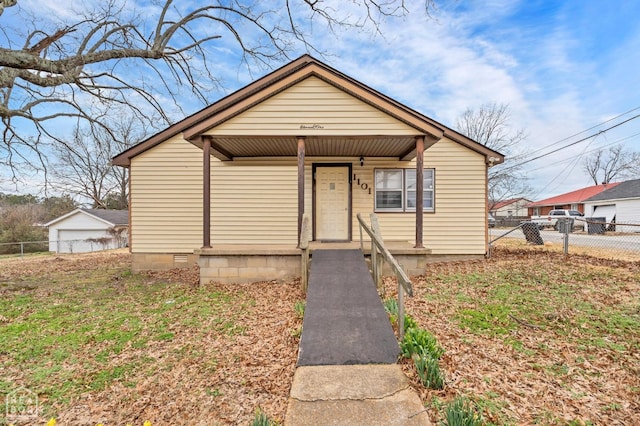 bungalow-style house featuring a porch, fence, and crawl space