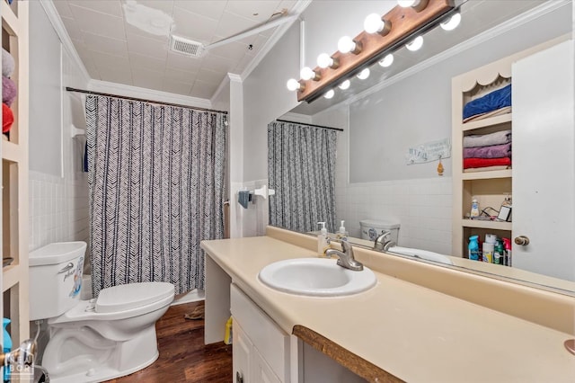 full bathroom with tile walls, visible vents, wood finished floors, and ornamental molding