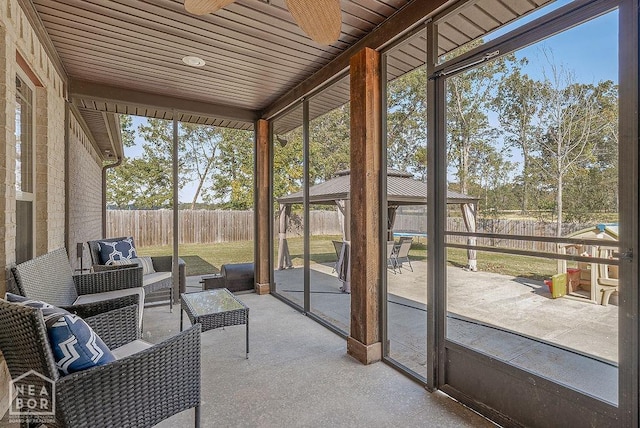sunroom / solarium with outdoor lounge area, a ceiling fan, and plenty of natural light