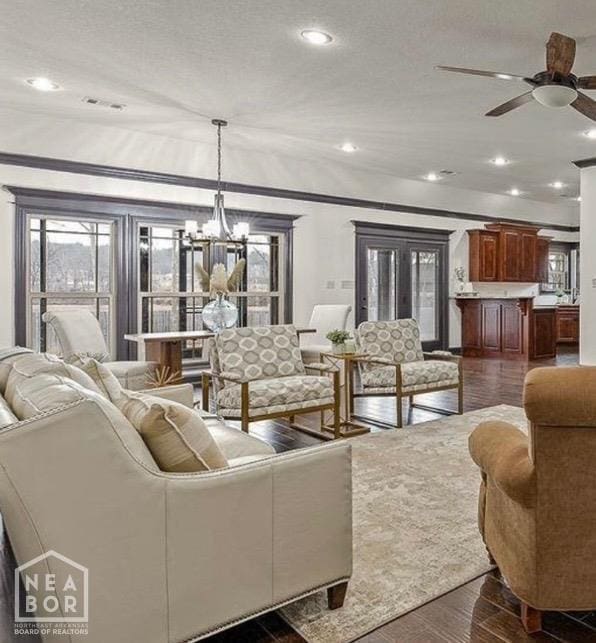 5200 Julia Cv, Jonesboro, AR 72404 - living room with recessed lighting, ornamental molding, ceiling fan with notable chandelier, and dark wood-style floors
