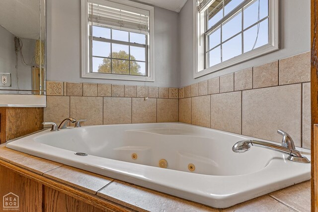 bathroom featuring a tub with jets