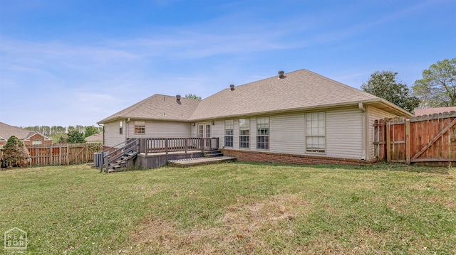 rear view of property with a lawn, a fenced backyard, cooling unit, a wooden deck, and roof with shingles