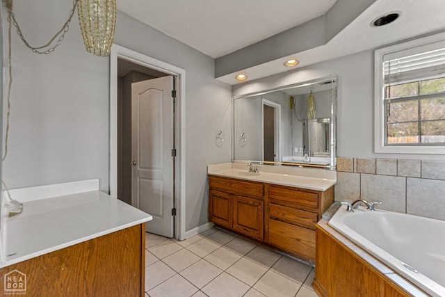 bathroom with tile patterned floors, vanity, and a garden tub