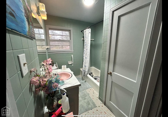 bathroom featuring tile patterned floors, a shower with shower curtain, vanity, and tile walls