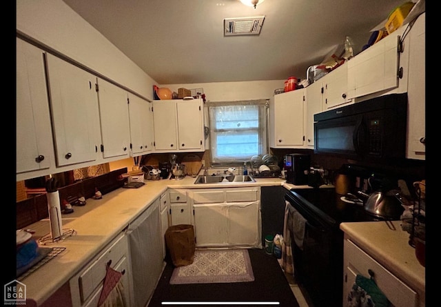 kitchen featuring light countertops, white cabinetry, black appliances, visible vents, and a sink