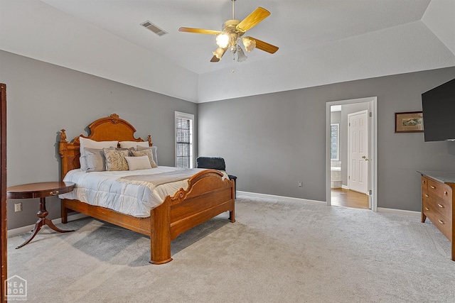 bedroom featuring vaulted ceiling, visible vents, light colored carpet, and baseboards