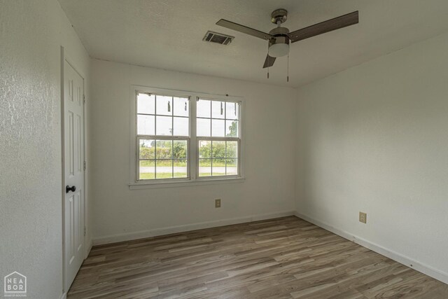 2303 E Lake St E, Paragould, AR 72450 - kitchen with a sink, light wood-type flooring, backsplash, dark cabinets, and pendant lighting